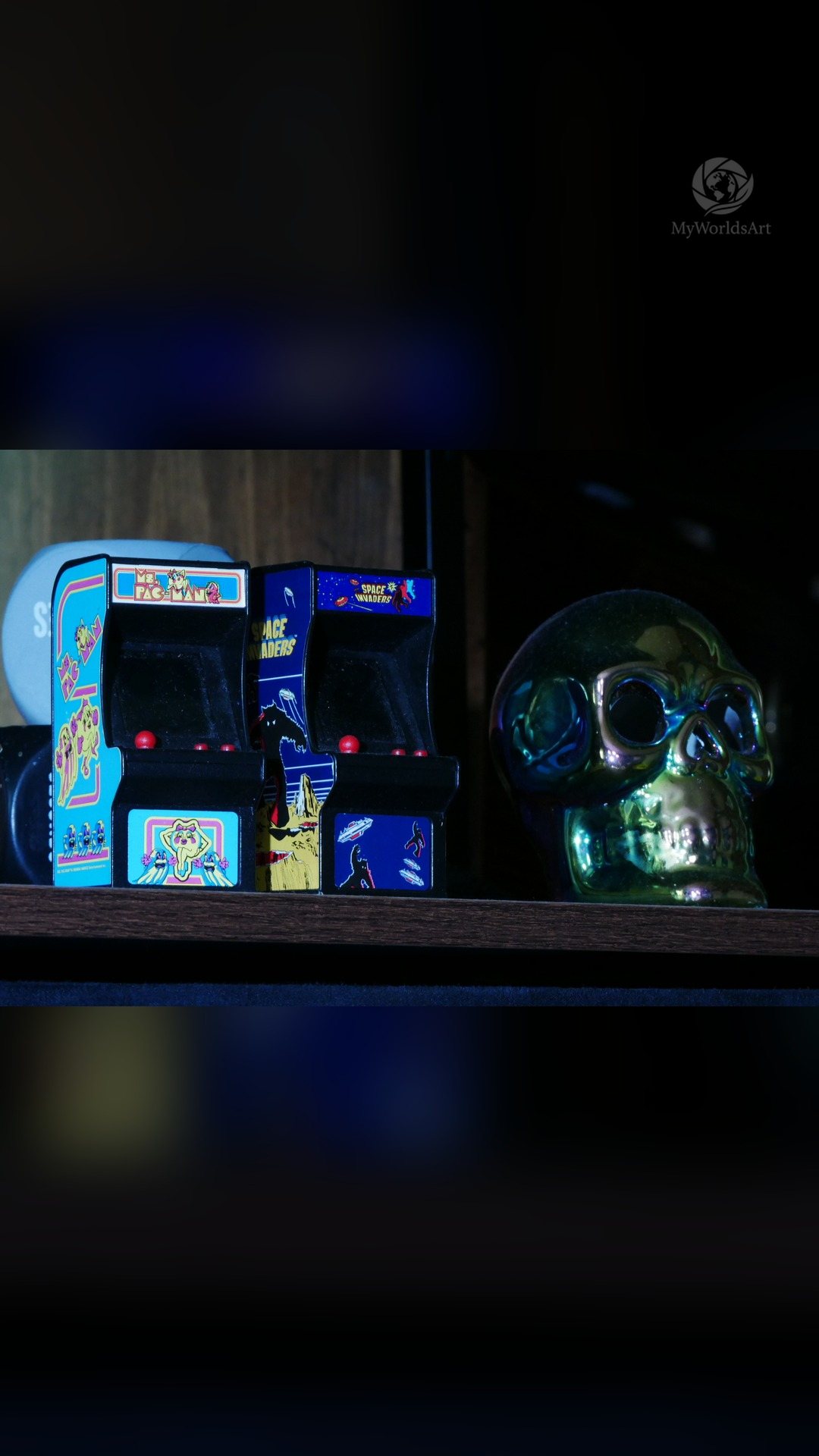 Mini arcade cabinets and a glass skull